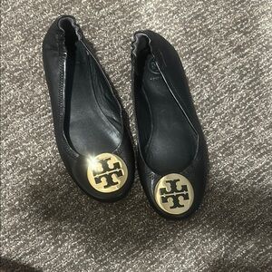 Tory Burch Black and Gold Leather Flats with Signature Medallion